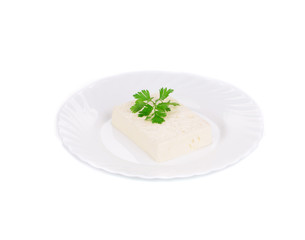 Tofu with parsley on a plate.