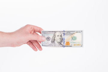 Hand holding 100 dollar bill.