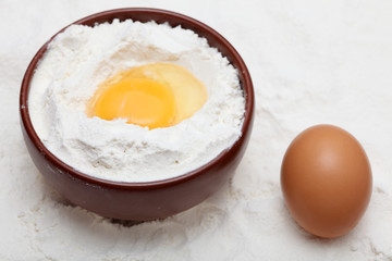 Flour in bowl and eggs