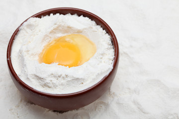 Flour with egg in bowl