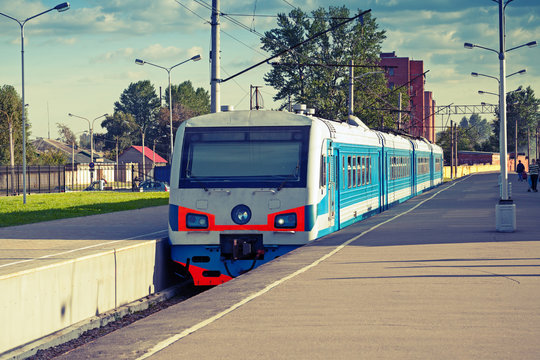 Modern suburban electric train standing at the station, photo wi