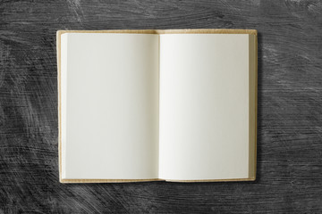 blank book open on a brown textured surface
