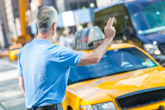 Senior Man Calling A Cab In New York