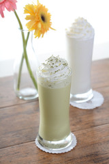 ice green tea and milk smoothie on a wood table