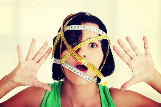 Woman with measuring tape around her head