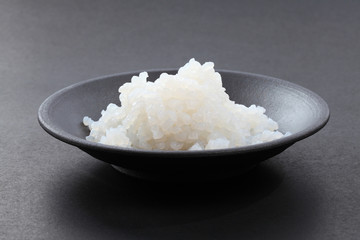 rice in black ceramic bowl