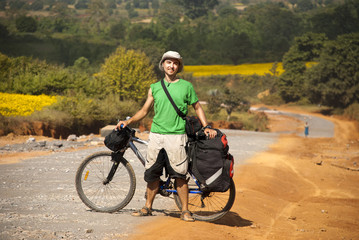 Bicycle tourist on the rural road in Burma (Myanmar), Shan State