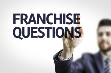 Business man pointing the text: Franchise Questions