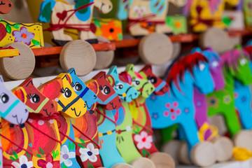 Fototapeta na wymiar Wooden horses on a market stall