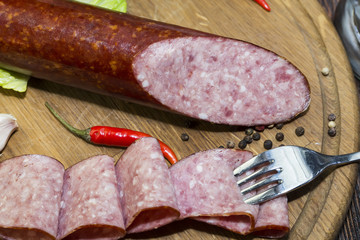 sausages on a wooden plate with vegetables in a restaurant