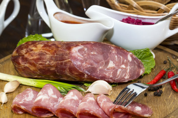 sausages on a wooden plate with vegetables in a restaurant