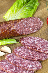 sausages on a wooden plate with vegetables in a restaurant