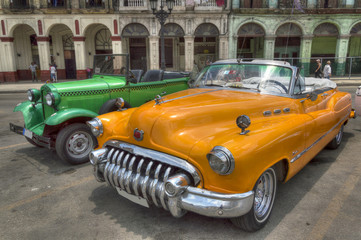 Orange and green cars in front of Capitolio, Havana, Cuba