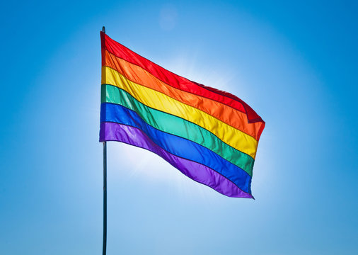 Rainbow Gay Pride Flag on blue sky background