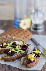 vegetarian sandwich with vegetables on a wooden background, vert