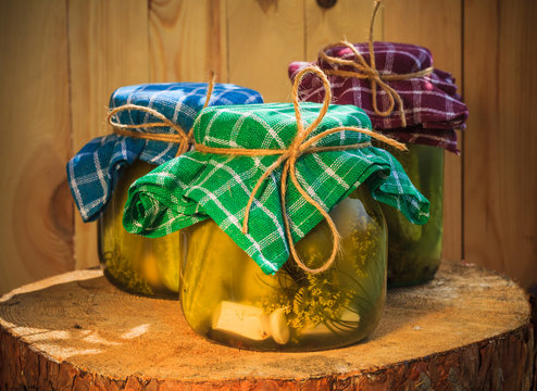 Jars pickled gherkins wooden table