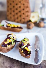 vegetarian sandwich with vegetables on white plate, vertically