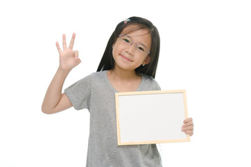 Little Asian girl holding empty whiteboard