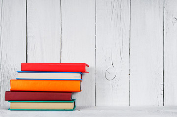 Books on a wooden shelf.