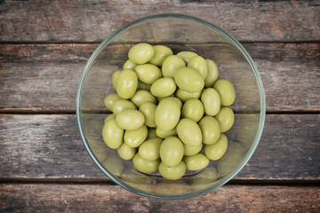 Almond in chocolate on wooden background