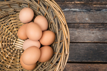eggs in basket on wooden background