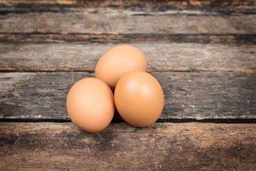 eggs in basket on wooden background
