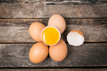 Chicken brown eggs on wooden background
