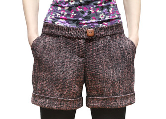 Women's shorts from wool tweed with hands in pockets isolated