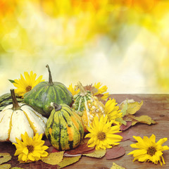 Autumn pumpkins with leaves on wooden table