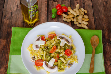 Pasta with basil pesto, nuts and mushrooms