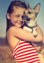 child hugging a puppy