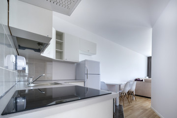 Fototapeta na wymiar Modern, white compact kitchen interior design