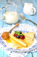 Flapjacks with berries and honey.