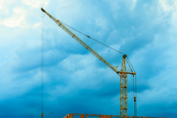 Construction site building crane on evening sky