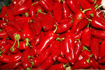 Red peppers on farmers market as background