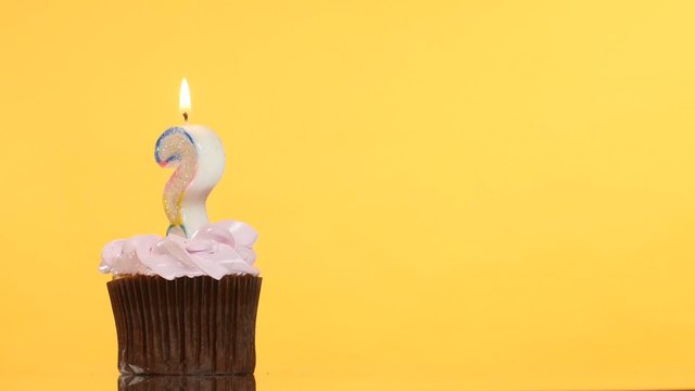 Birthday cupcake with candle question mark.