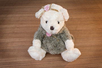Toy teddy bear on wooden background