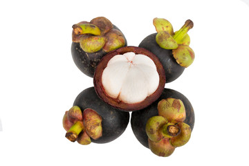 Mangosteen and cross section showing the thick purple skin