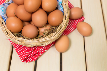Eggs in a basket on wooden table