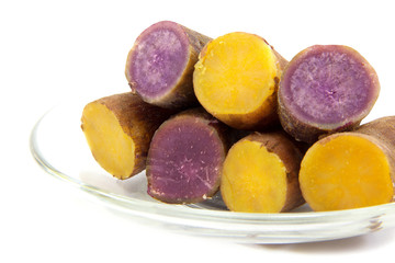 Boiled purple  and yellow yams boiled in plate on white backgrou
