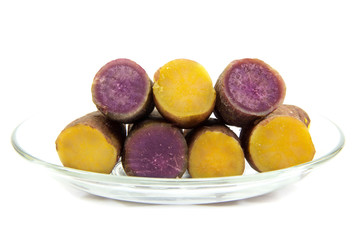 Boiled purple and yellow yams in plate on white background