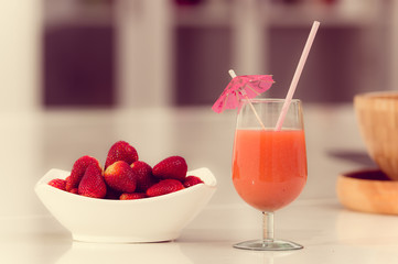 Delicous strawberry juice in a glass and fresh strawberries on