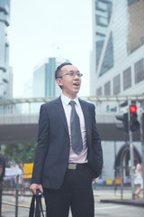 hong kong businessman in busy central district, light vintage bl