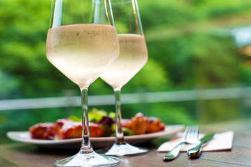 Two glasses of delicious cooled white wine with snack.