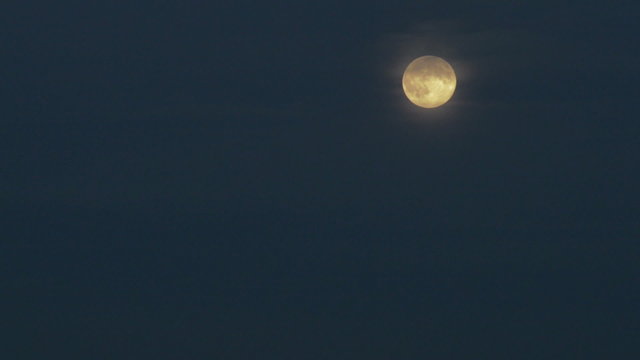 Full moon over dark blue sky.