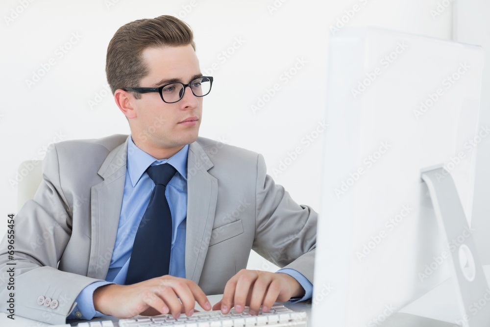 Poster nerdy businessman working on computer