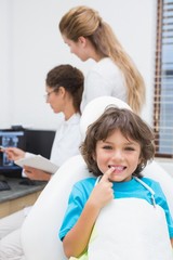 Little boy smiling at camera with mother