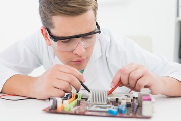 Technician working on broken cpu with soldering iron