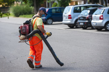 Man using electric leaf blowers