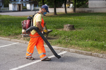 Man using electric leaf blowers